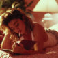 Madonna reading a book lying on the bed