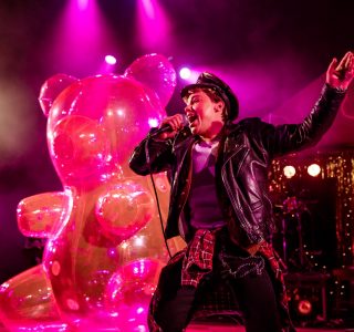 Elijah Ferreira performs with Yitzhak with a pink inflatable bear in Hedwig and the Angry Inch